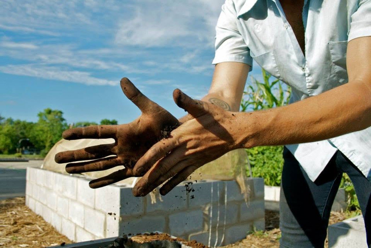 Working with soil at The Cooperation Operation. Photograph: Monica Wizgird, 2013.